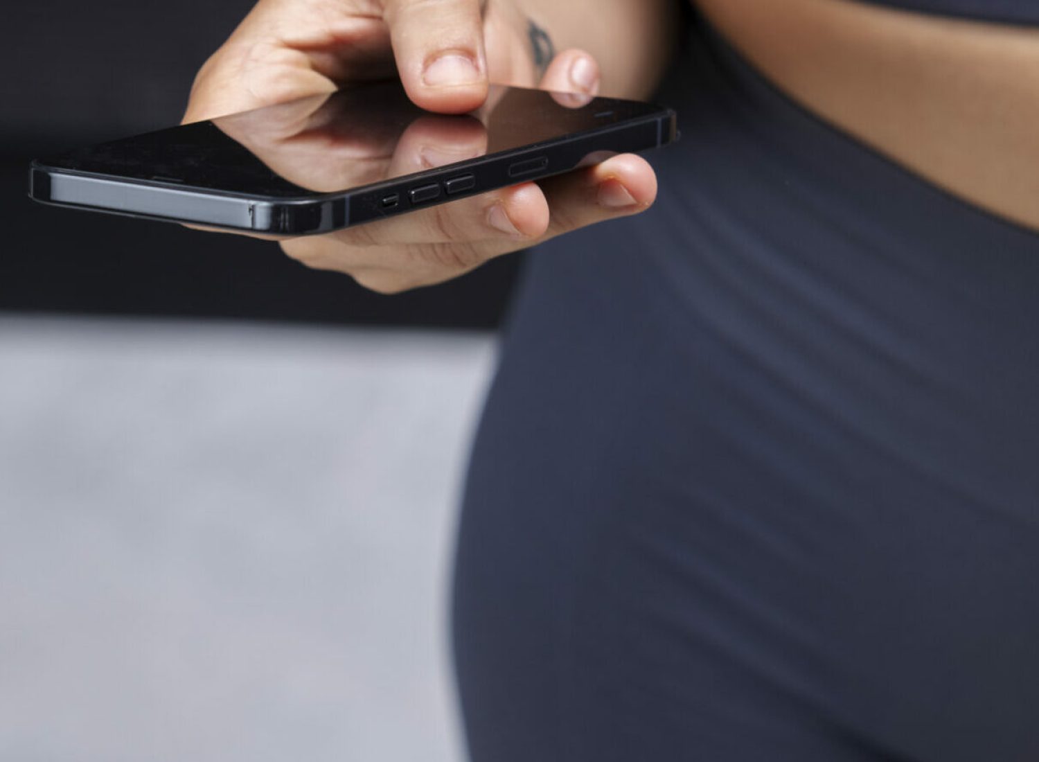 close-up-fit-woman-holding-smartphone